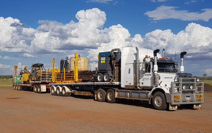 white truck loaded with equipment