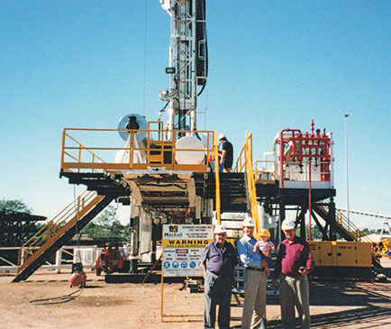 four generations of mitchell family in front of drilling rig